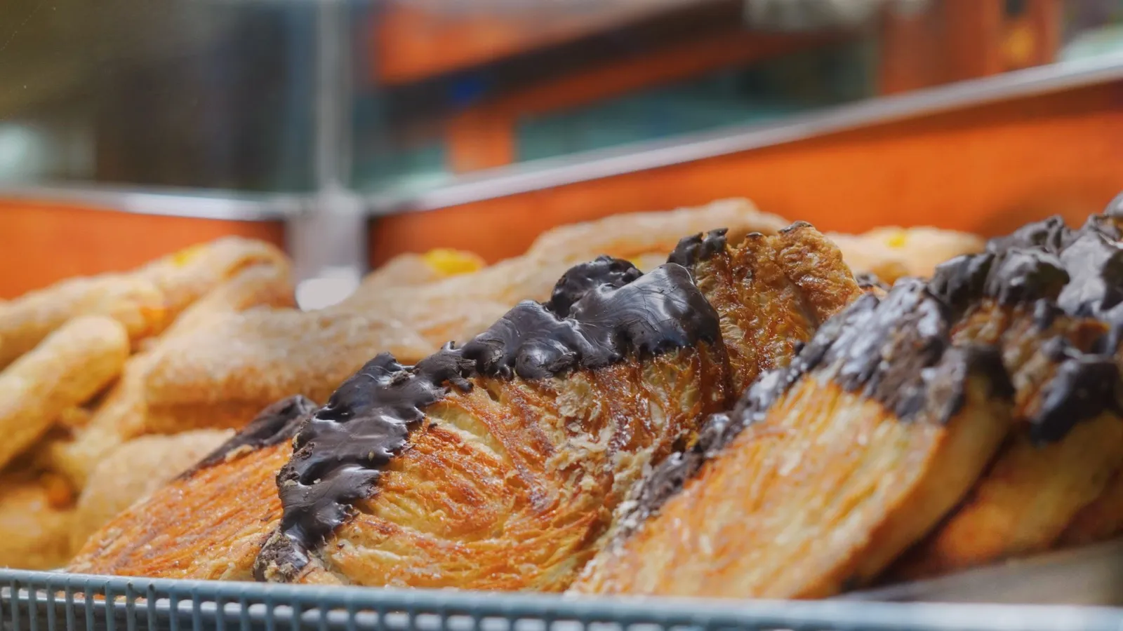 Fresh chocolate-topped Mexican pastries in the bakery case at Taqueria Market Portland